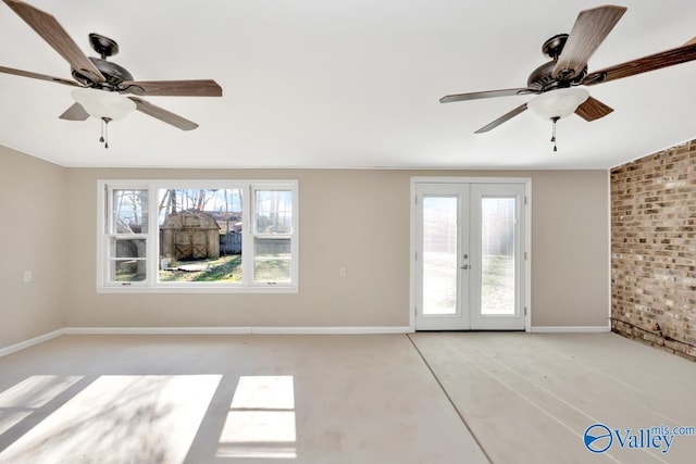 spare room featuring ceiling fan and french doors