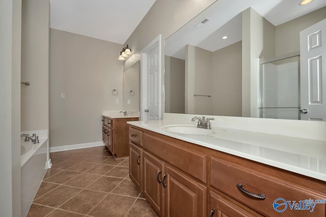 bathroom featuring a bathing tub, tile patterned flooring, and vanity