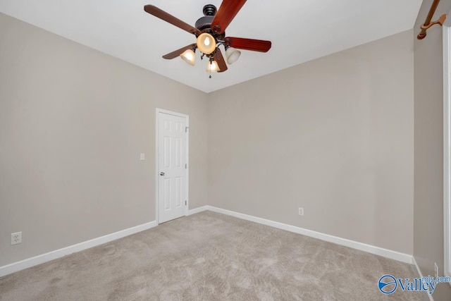 unfurnished room featuring light colored carpet and ceiling fan