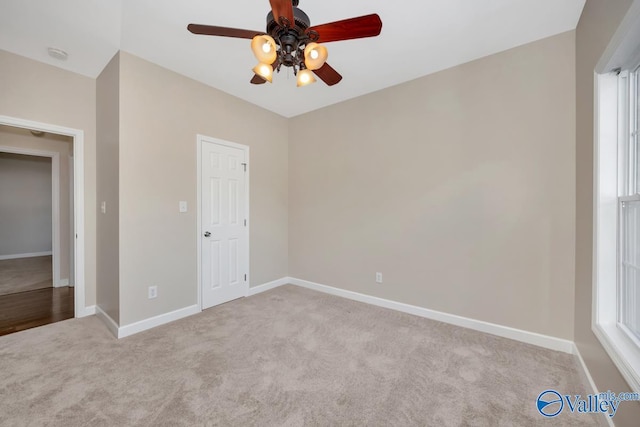 unfurnished bedroom with light carpet and ceiling fan