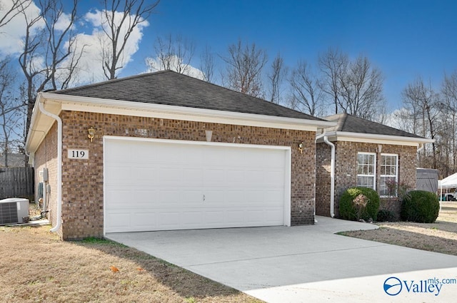 view of front of home with a garage and central AC unit