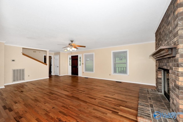 156 San Leonardo Way, Huntsville, AL 35811 - unfurnished living room with wood finished floors, a ceiling fan, a fireplace, crown molding, and baseboards