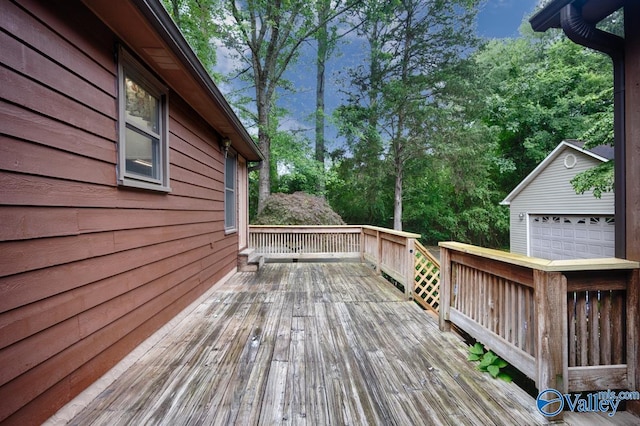 156 San Leonardo Way, Huntsville, AL 35811 - wooden deck featuring a detached garage, view of scattered trees, and an outdoor structure