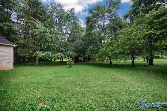 156 San Leonardo Way, Huntsville, AL 35811 - view of grassy yard featuring view of wooded area