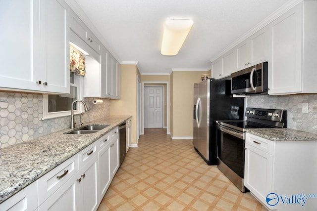 156 San Leonardo Way, Huntsville, AL 35811 - kitchen with stainless steel appliances, a sink, light floors, white cabinetry, and baseboards