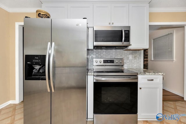 156 San Leonardo Way, Huntsville, AL 35811 - kitchen with stainless steel appliances, crown molding, white cabinetry, light stone countertops, and baseboards
