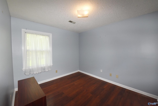 1208 SE Teenajo Dr SE, Huntsville, AL 35803 - empty room with dark wood-type flooring and a textured ceiling