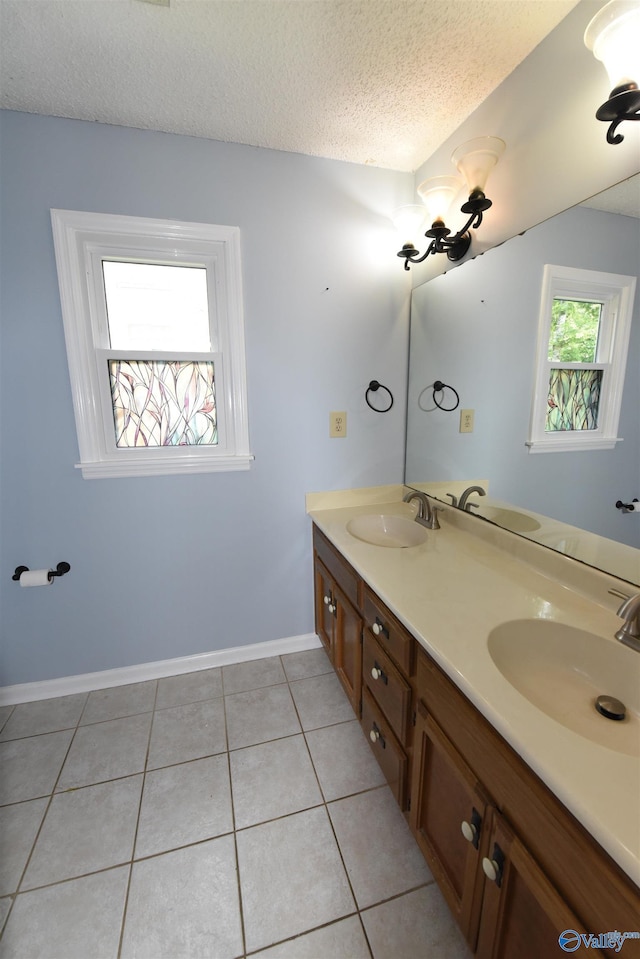 1208 SE Teenajo Dr SE, Huntsville, AL 35803 - bathroom featuring double vanity, tile patterned flooring, and a textured ceiling