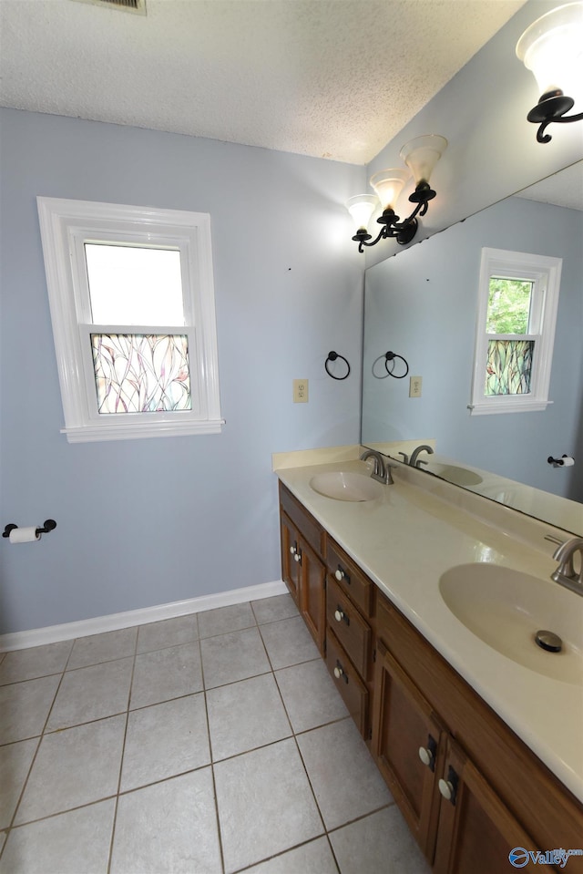 1208 SE Teenajo Dr SE, Huntsville, AL 35803 - bathroom featuring double vanity, tile patterned flooring, and a textured ceiling