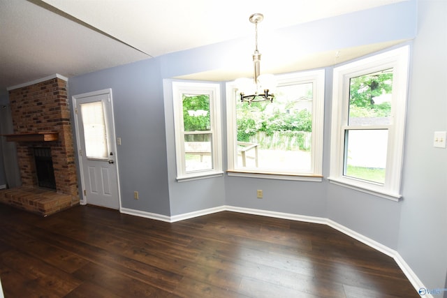 1208 SE Teenajo Dr SE, Huntsville, AL 35803 - unfurnished dining area featuring a chandelier, dark wood-type flooring, and a fireplace