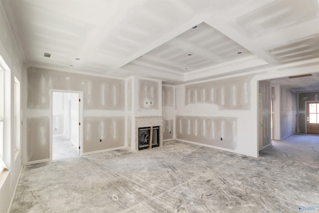 unfurnished living room featuring coffered ceiling and a fireplace