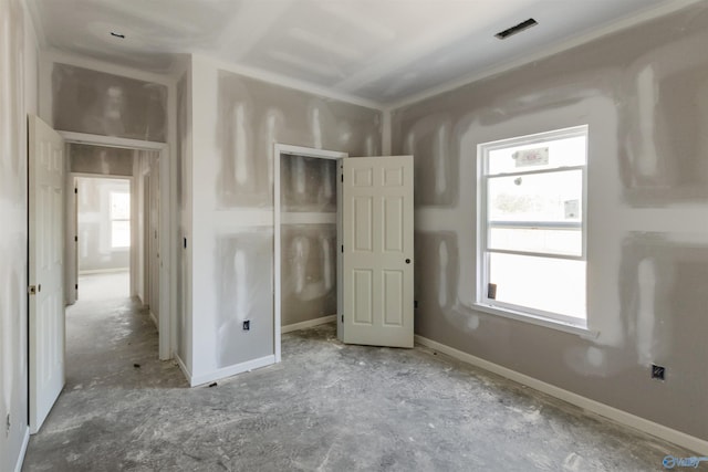 unfurnished bedroom with visible vents and baseboards