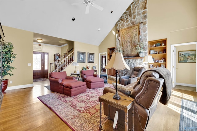 living room featuring light hardwood / wood-style floors, high vaulted ceiling, and ceiling fan