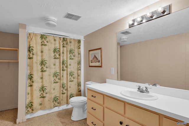 bathroom featuring a textured ceiling, toilet, vanity, and a shower with curtain