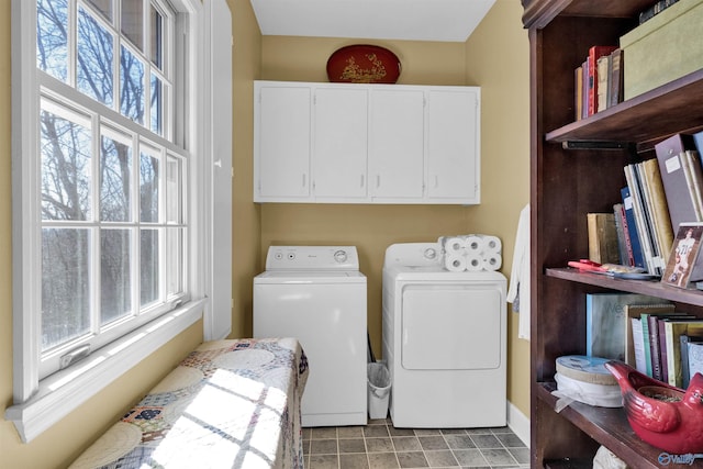 laundry room with washer and dryer and cabinets