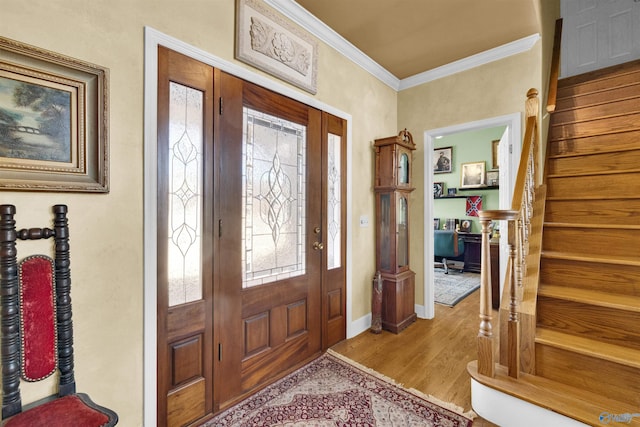 foyer entrance featuring ornamental molding and light wood-type flooring