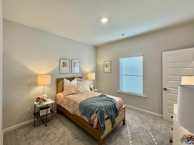 bedroom with carpet floors and baseboards