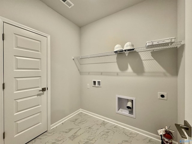 laundry area featuring electric dryer hookup, washer hookup, marble look tile flooring, and baseboards