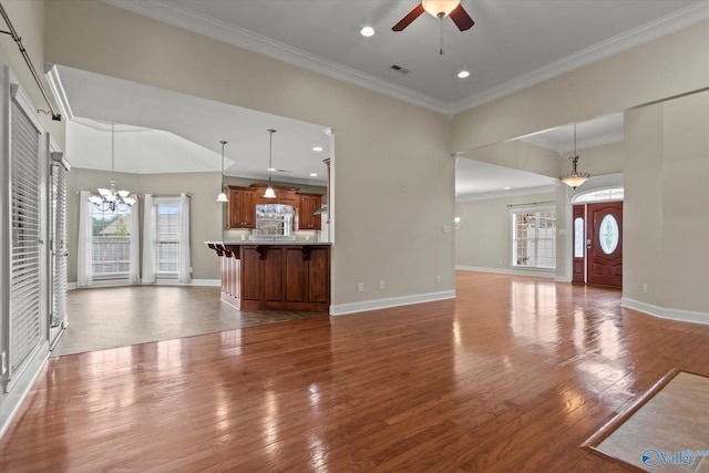2201 Martinwood Ln SW, Decatur, AL 35603 - unfurnished living room featuring a chandelier, a ceiling fan, crown molding, wood finished floors, and baseboards