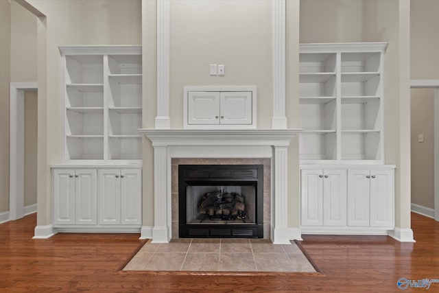 2201 Martinwood Ln SW, Decatur, AL 35603 - detailed view of wood finished floors, baseboards, built in features, and a tiled fireplace