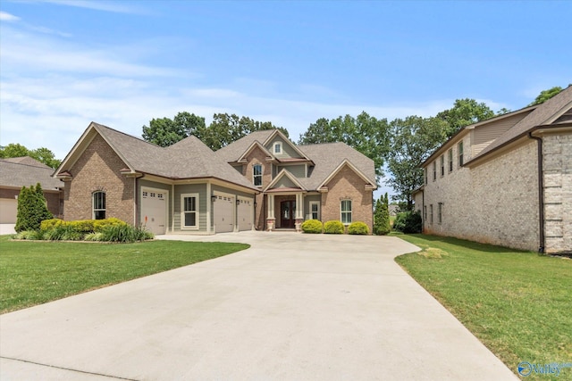 14318 Muirfield Dr, Athens, AL 35613 - view of front of house with brick siding, a garage, a front yard, and concrete driveway