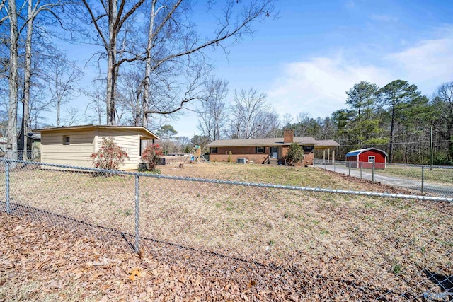 view of front of home featuring an outdoor structure, a chimney, and fence