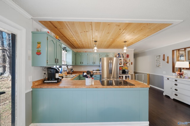 kitchen featuring black electric stovetop, wooden ceiling, a peninsula, dark wood-style flooring, and freestanding refrigerator