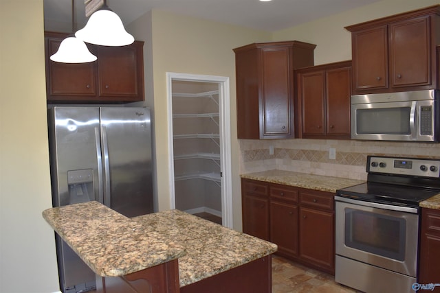 kitchen with light stone countertops, decorative backsplash, appliances with stainless steel finishes, a kitchen bar, and decorative light fixtures