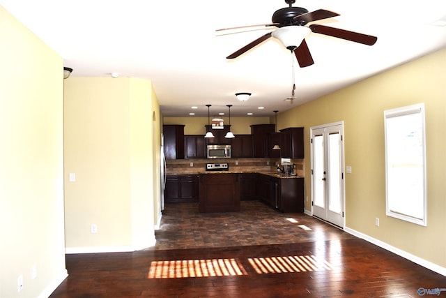 kitchen featuring dark brown cabinetry, pendant lighting, sink, stainless steel appliances, and dark hardwood / wood-style flooring