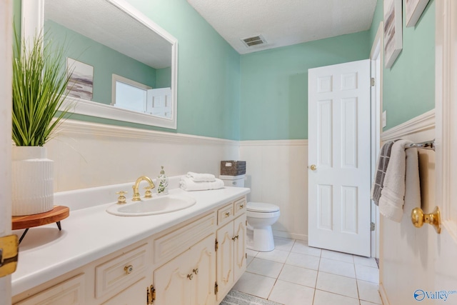 bathroom with toilet, tile patterned floors, vanity, and visible vents
