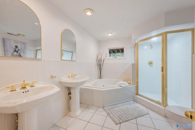 full bath featuring a stall shower, a garden tub, tile patterned flooring, and tile walls