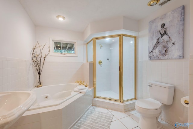 full bath featuring a bath, toilet, tile walls, a shower stall, and tile patterned floors