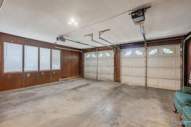 garage with wooden walls and a garage door opener