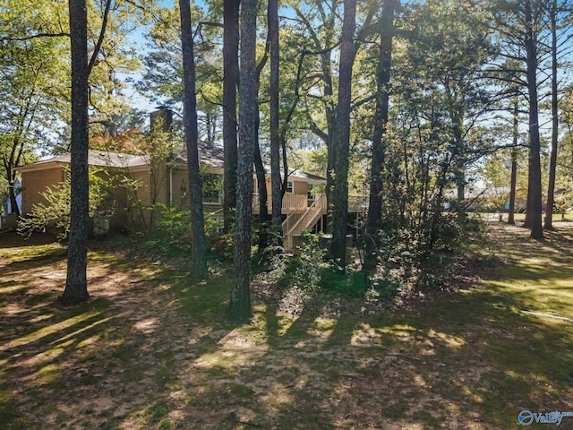 view of yard featuring stairs and a deck