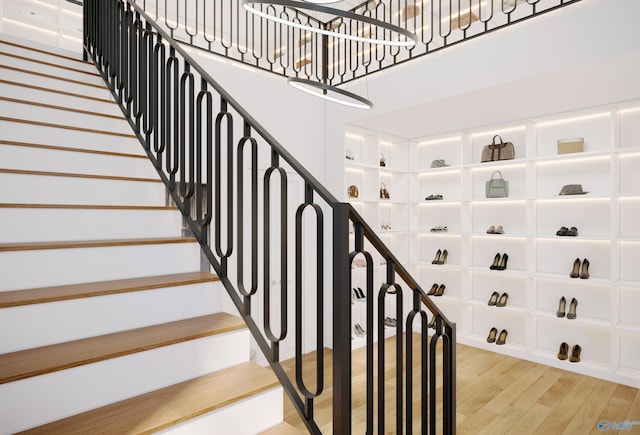 staircase with hardwood / wood-style flooring