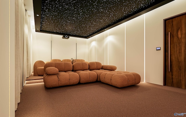 carpeted home theater featuring a decorative wall