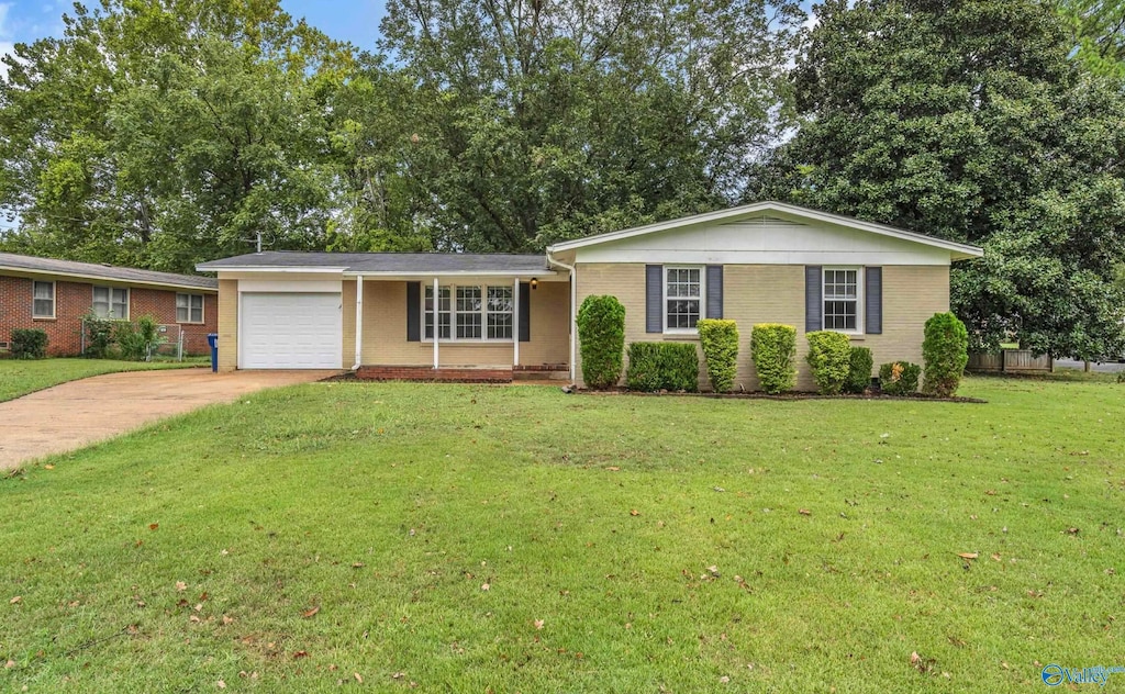 ranch-style house featuring a front yard and a garage