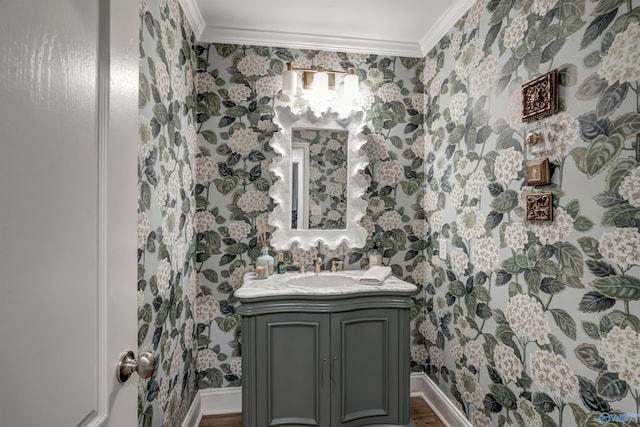 bathroom featuring ornamental molding, wood-type flooring, and vanity