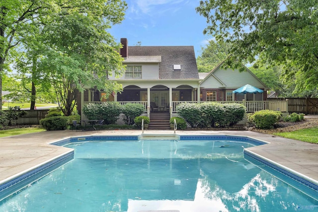 view of swimming pool with a sunroom