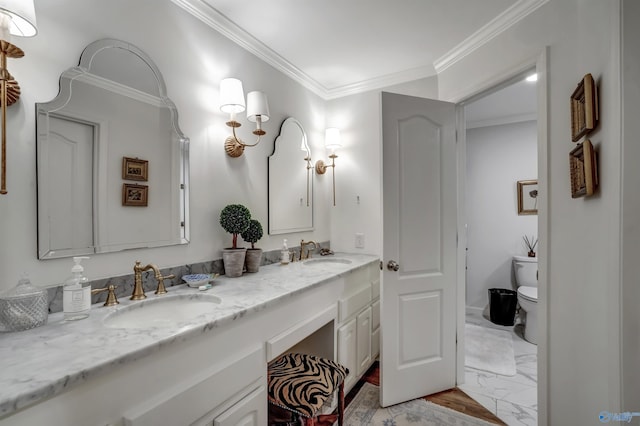 bathroom with vanity, crown molding, and toilet