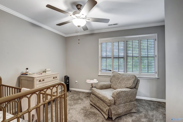 sitting room with ornamental molding, carpet, and ceiling fan