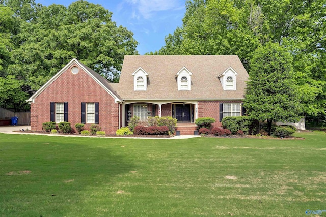 cape cod home with a front yard