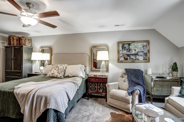 carpeted bedroom with vaulted ceiling, ornamental molding, and ceiling fan