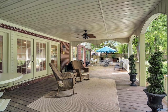 wooden terrace featuring ceiling fan and french doors