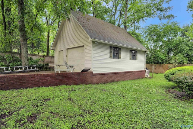 view of property exterior with a garage and a yard