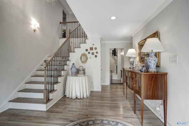 foyer entrance featuring ornamental molding and dark hardwood / wood-style flooring