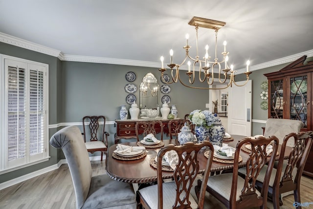 dining space with light hardwood / wood-style flooring and ornamental molding