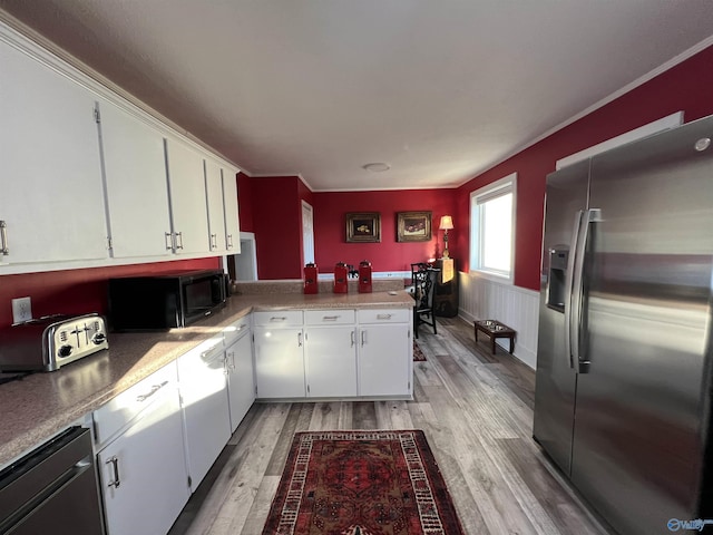 kitchen with white cabinets, dishwasher, light countertops, black microwave, and stainless steel refrigerator with ice dispenser