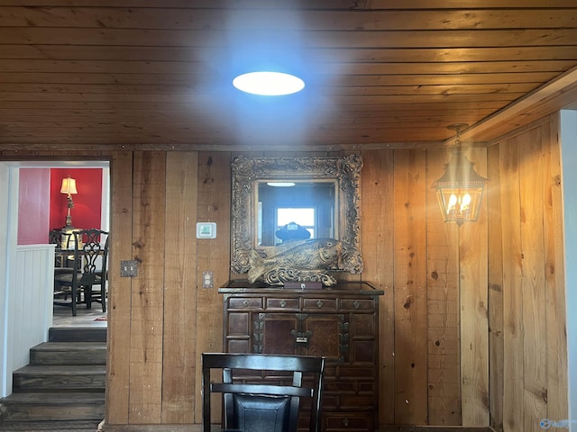 hall featuring wooden ceiling and wood walls