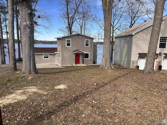 view of front of property with a water view and fence